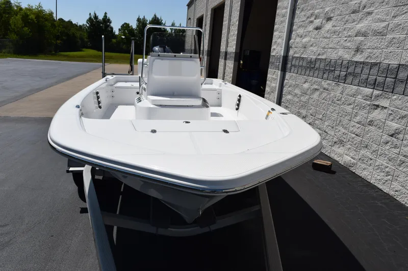 Slide: The Image of 2026 Frontier 180 boat parked outside a building on a sunny day. - 3