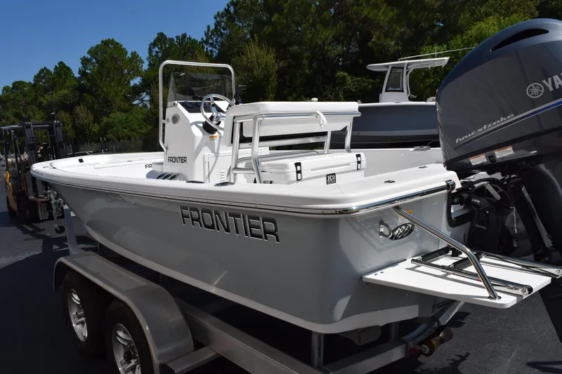 Slide: The Image of 2026 Frontier 180 boat on trailer with Yamaha outboard motor, parked outdoors. - 6