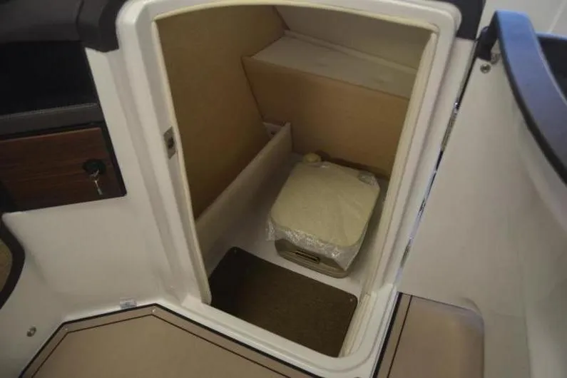 Slide: The Image of 2018 Cobalt R5 Surf boat interior storage compartment with a portable toilet. - 8