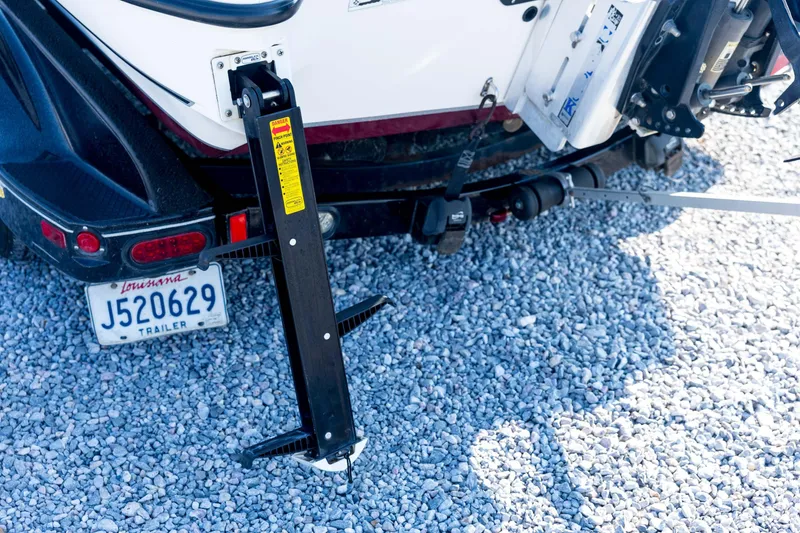 Slide: The Image of 2011 Triton 20XS DC boat trailer with Louisiana license plate on gravel surface. - 21