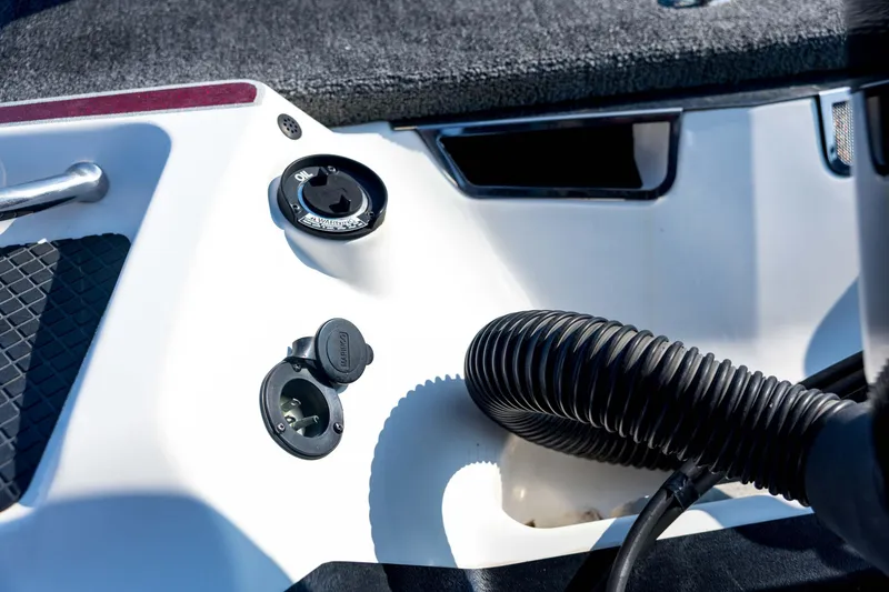 Slide: The Image of Control panel of a 2011 Triton 20XS DC boat with various switches and ports. - 24