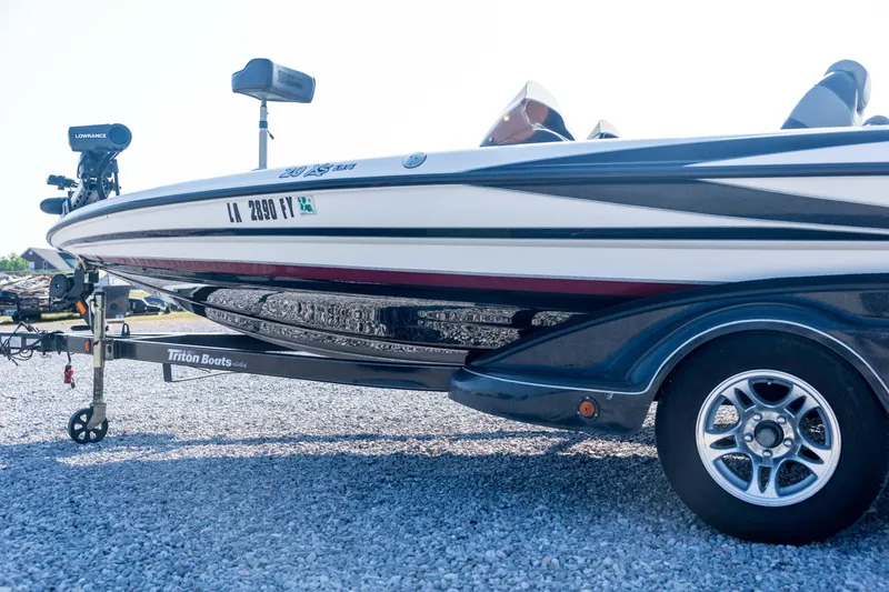 Slide: The Image of 2011 Triton 20XS DC boat on trailer, featuring sleek design and modern equipment. - 26