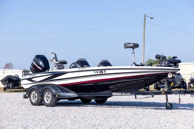 Slide: The Image of 2011 Triton 20XS DC boat on trailer, featuring sleek design and Mercury engine. - 3