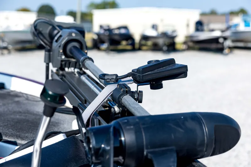 Slide: The Image of Close-up of a 2011 Triton 20XS DC boat motor in a marina setting. - 30