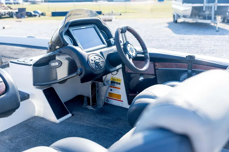 Slide: The Image of Interior of 2011 Triton 20XS DC boat showing steering wheel and dashboard controls. - 34