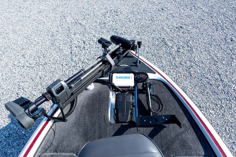 Slide: The Image of 2011 Triton 20XS DC boat deck with Lowrance electronics and trolling motor on gravel background. - 37