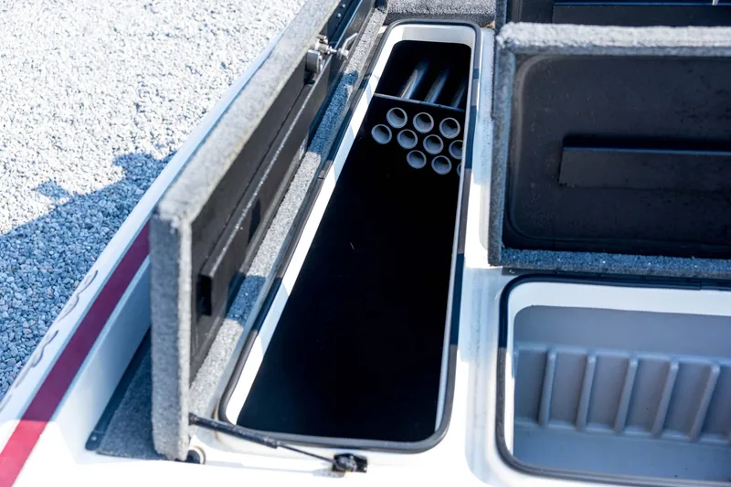 Slide: The Image of Open storage compartment in 2011 Triton 20XS DC boat, featuring rod holders and organized space. - 42