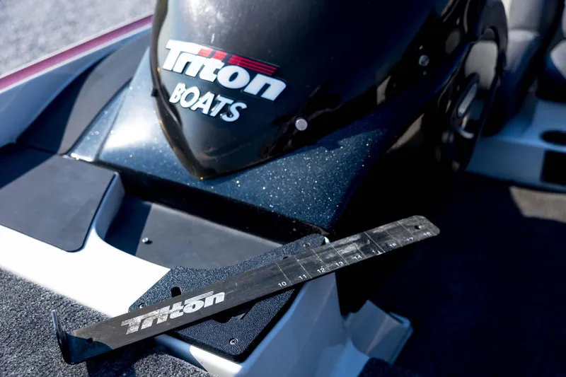 Slide: The Image of 2011 Triton 20XS DC boat with branded measuring tool on deck. - 46