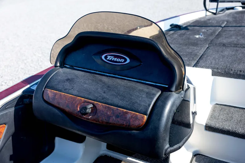 Slide: The Image of 2011 Triton 20XS DC boat dashboard with logo and protective cover. - 48
