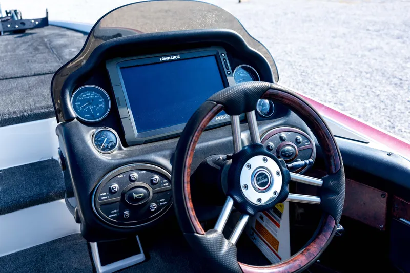 Slide: The Image of 2011 Triton 20XS DC boat dashboard with steering wheel and Lowrance display. - 49