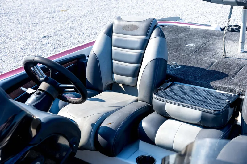 Slide: The Image of 2011 Triton 20XS DC boat interior with steering wheel and cushioned seats. - 56
