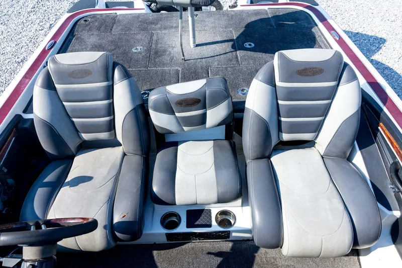 Slide: The Image of 2011 Triton 20XS DC boat interior with three gray and black seats. - 58