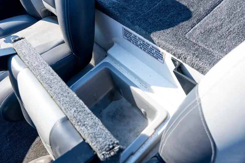 Slide: The Image of 2011 Triton 20XS DC boat interior with storage compartment and seating. - 59