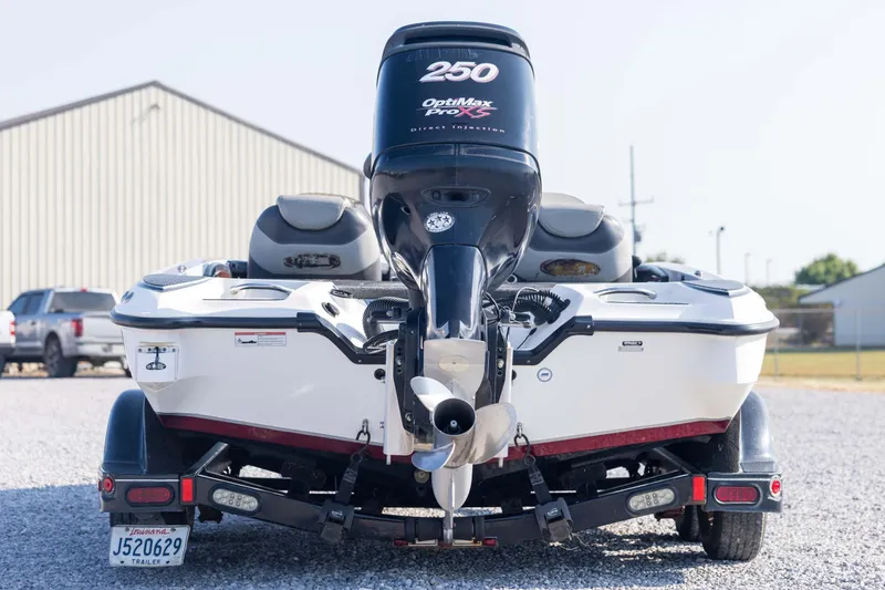 Slide: The Image of 2011 Triton 20XS DC boat with powerful outboard motor, parked on gravel. - 6