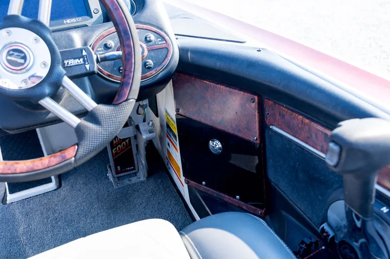 Slide: The Image of Interior of 2011 Triton 20XS DC boat showing steering wheel and dashboard controls. - 62