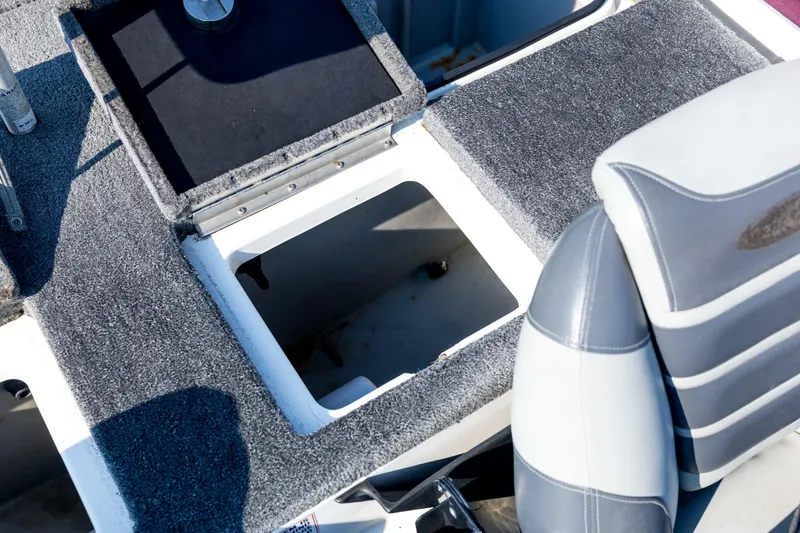 Slide: The Image of 2011 Triton 20XS DC boat interior with open storage compartment and seating. - 67