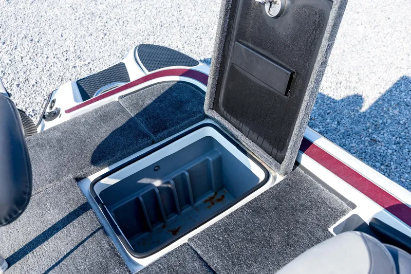 Slide: The Image of Open storage compartment on 2011 Triton 20XS DC boat, featuring carpeted interior. - 68