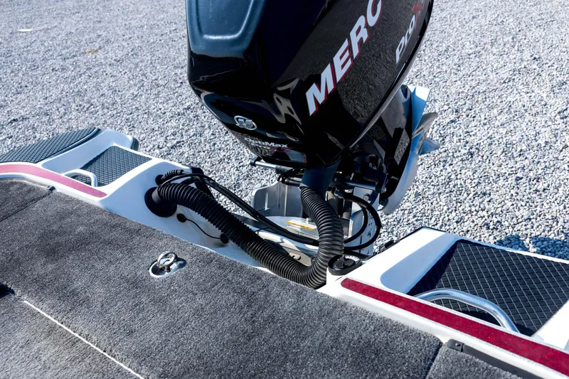 Slide: The Image of 2011 Triton 20XS DC boat with Mercury engine on gravel surface. - 71