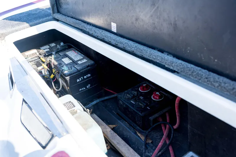Slide: The Image of Battery compartment of a 2011 Triton 20XS DC boat, showing wiring and connections. - 73