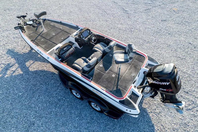 Slide: The Image of 2011 Triton 20XS DC boat with Mercury Pro XS engine on gravel surface. - 76