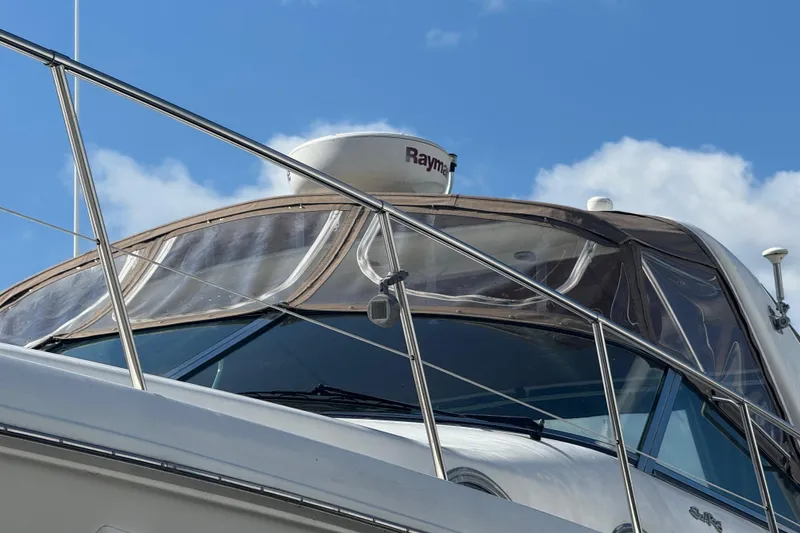 Slide: The Image of 1999 Sea Ray Sundancer 400 yacht with radar, clear skies, and stainless steel railings. - 10