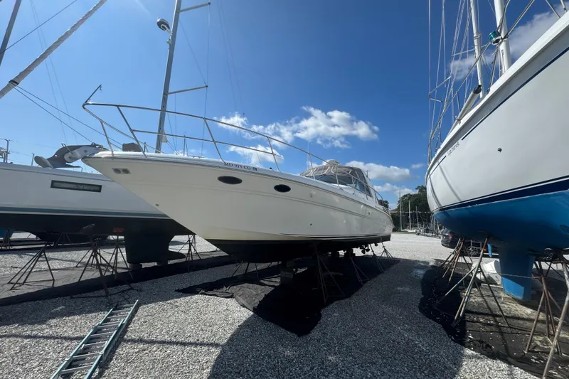 Slide: The Image of 1999 Sea Ray Sundancer 400 yacht on dry dock under clear blue sky. - 11