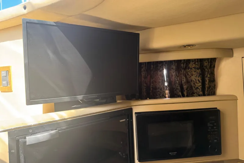 Slide: The Image of Interior of 1999 Sea Ray Sundancer 400 with TV, microwave, and patterned curtains. - 18