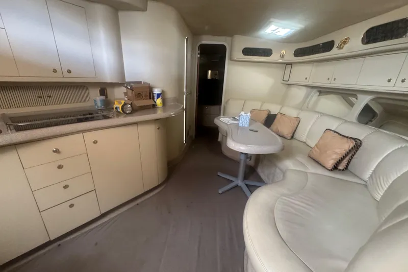 Slide: The Image of Interior of 1999 Sea Ray Sundancer 400 yacht with kitchen and seating area. - 21