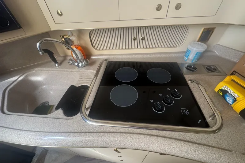 Slide: The Image of 1999 Sea Ray Sundancer 400 kitchen with sink and electric stovetop. - 24