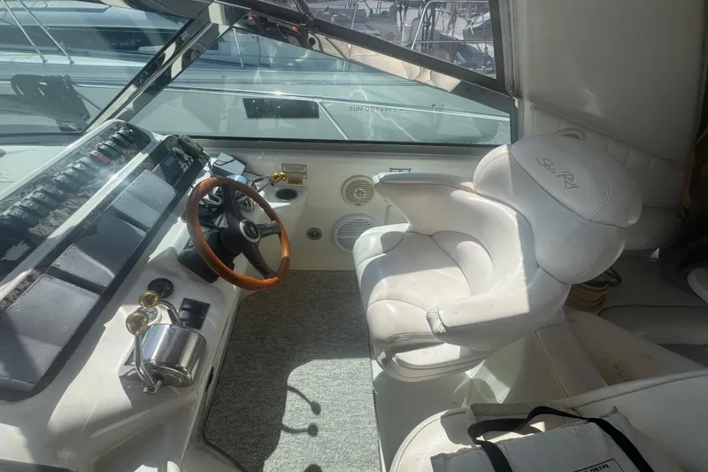 Slide: The Image of 1999 Sea Ray Sundancer 400 helm with white captain's chair and wooden steering wheel. - 3