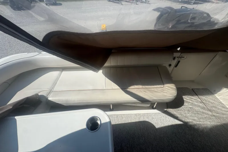 Slide: The Image of 1999 Sea Ray Sundancer 400 interior seating area with beige upholstery and carpet flooring. - 35