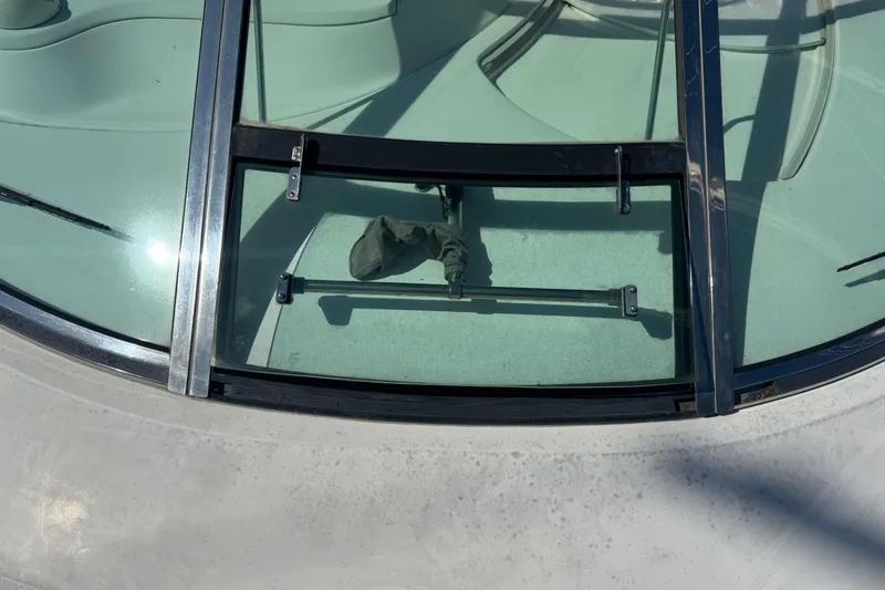 Slide: The Image of 1999 Sea Ray Sundancer 400 windshield with open hatch and visible hardware. - 39