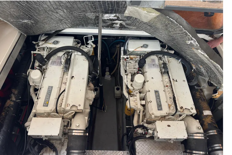 Slide: The Image of Engine compartment of a 1999 Sea Ray Sundancer 400, featuring dual marine engines. - 48