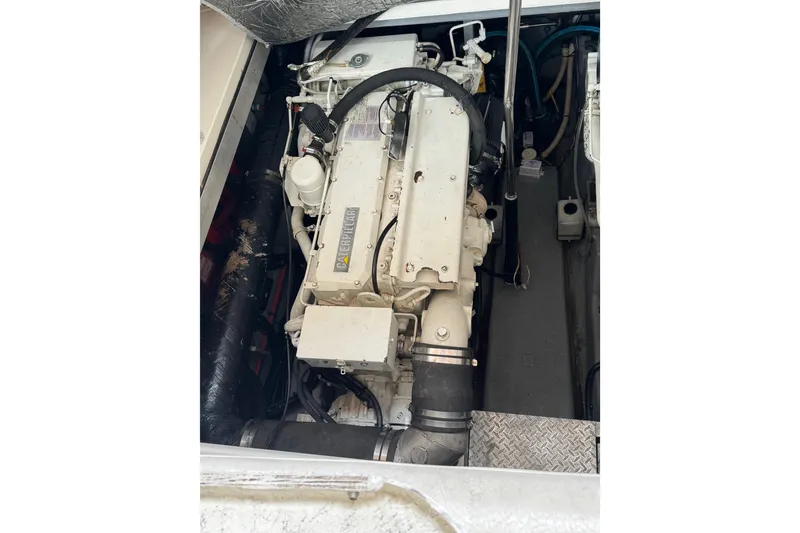 Slide: The Image of Engine compartment of a 1999 Sea Ray Sundancer 400 boat, showcasing detailed machinery. - 49