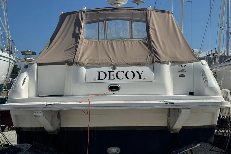 Slide: The Image of 1999 Sea Ray Sundancer 400 boat named "Decoy" with brown canvas cover. - 7
