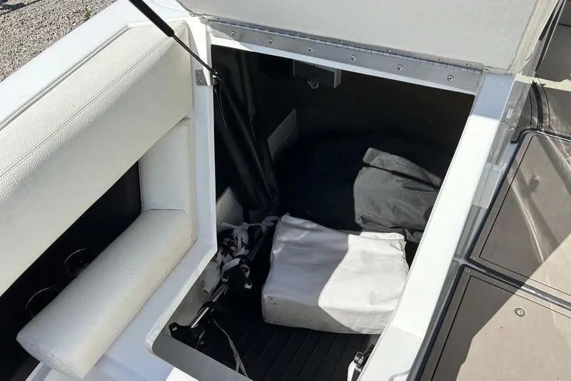Slide: The Image of Open storage compartment in a 2017 Cobalt R30 boat, showing interior space. - 2