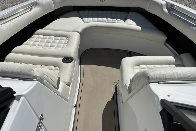 Slide: The Image of 2017 Cobalt R30 boat interior with white cushioned seating and beige flooring. - 3
