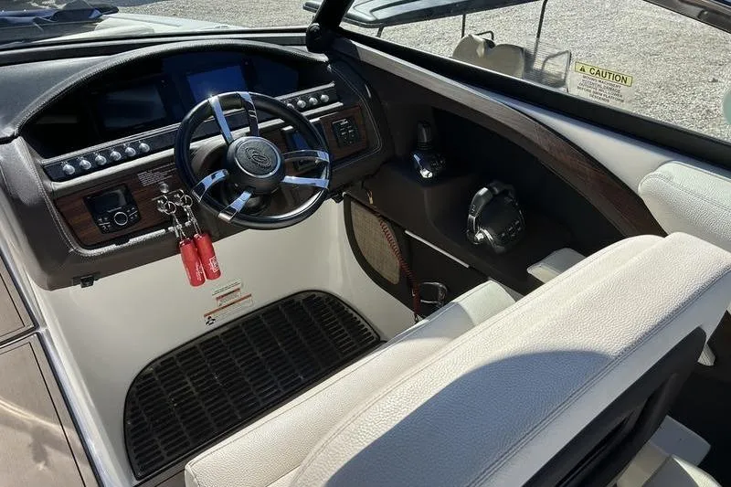 Slide: The Image of 2017 Cobalt R30 boat cockpit with steering wheel and control panel. - 7