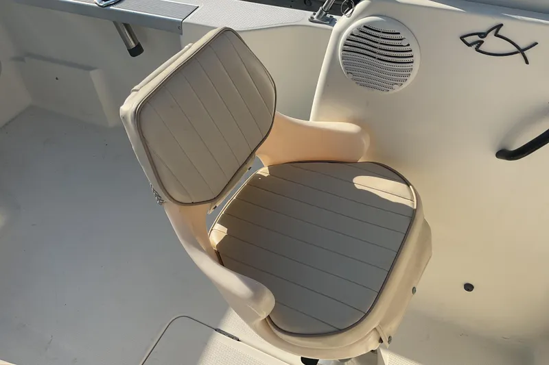 Slide: The Image of Boat seat on 2002 Trophy 1802 Walkaround, featuring beige upholstery and marine speaker. - 12