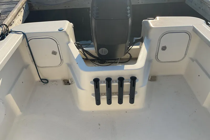 Slide: The Image of 2002 Trophy 1802 Walkaround boat interior with rod holders and storage compartments. - 13