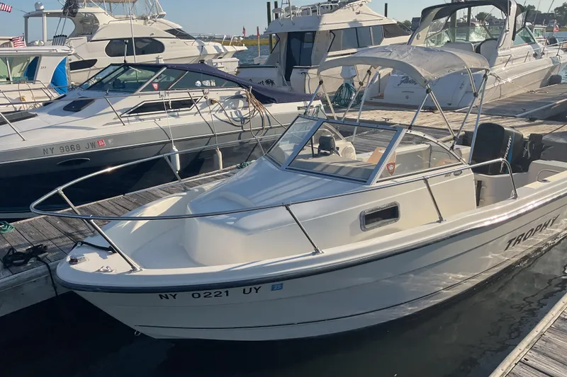 Slide: The Image of 2002 Trophy 1802 Walkaround boat docked at marina, sunny day. - 3