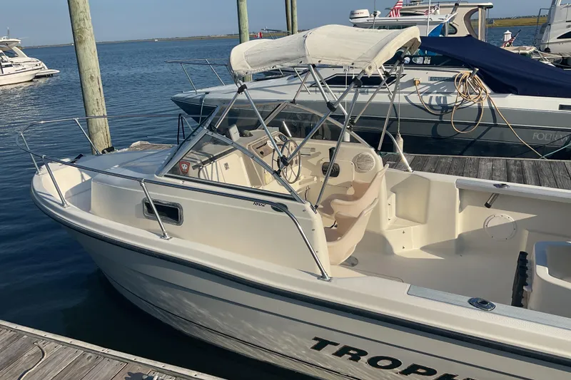Slide: The Image of 2002 Trophy 1802 Walkaround boat docked at marina, featuring open cockpit and canopy. - 5