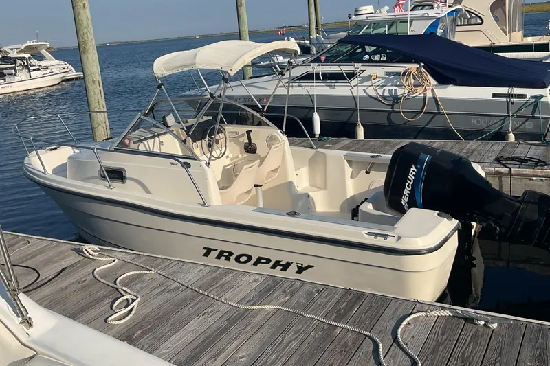 Slide: The Image of 2002 Trophy 1802 Walkaround boat docked with Mercury outboard motor. - 6