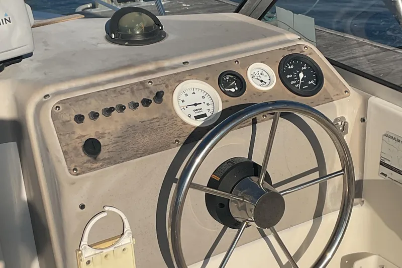 Slide: The Image of 2002 Trophy 1802 Walkaround boat dashboard with steering wheel and gauges. - 8