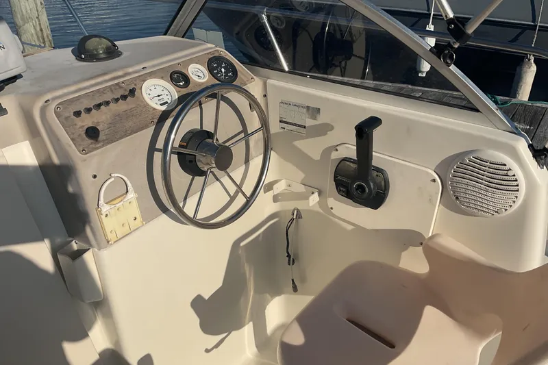 Slide: The Image of 2002 Trophy 1802 Walkaround boat helm with steering wheel and control panel. - 9