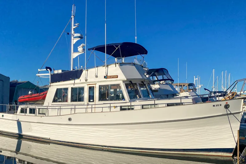 The Image of 1984 Grand Banks 49 Classic yacht docked in harbor. - 0
