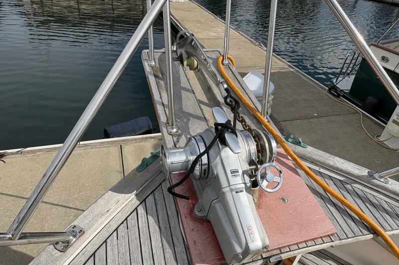 Slide: The Image of 1984 Grand Banks Classic yacht deck with anchor winch and dock view. - 10