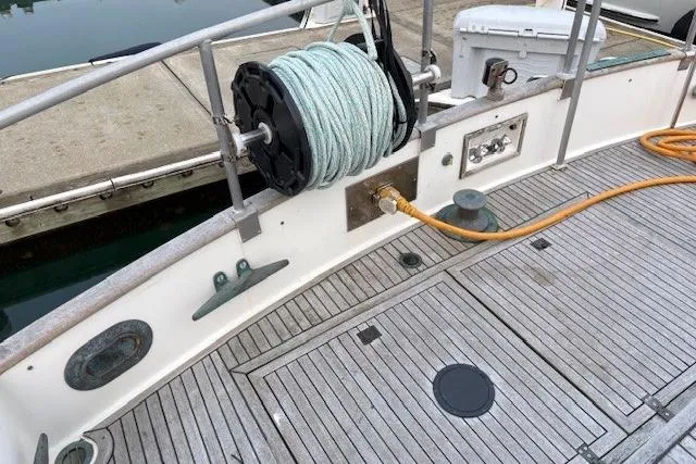 Slide: The Image of 1984 Grand Banks Classic boat deck with coiled rope and dockside connection. - 15