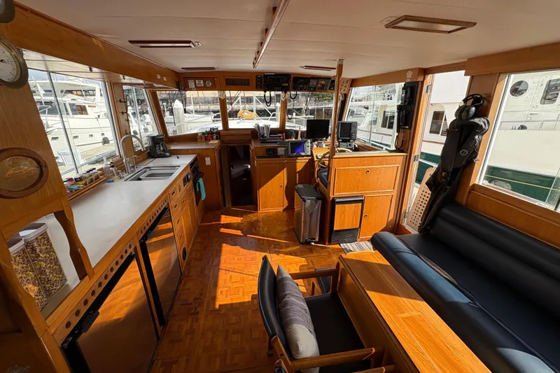 Slide: The Image of Interior of 1984 Grand Banks Classic yacht with wooden cabinetry and modern navigation equipment. - 21