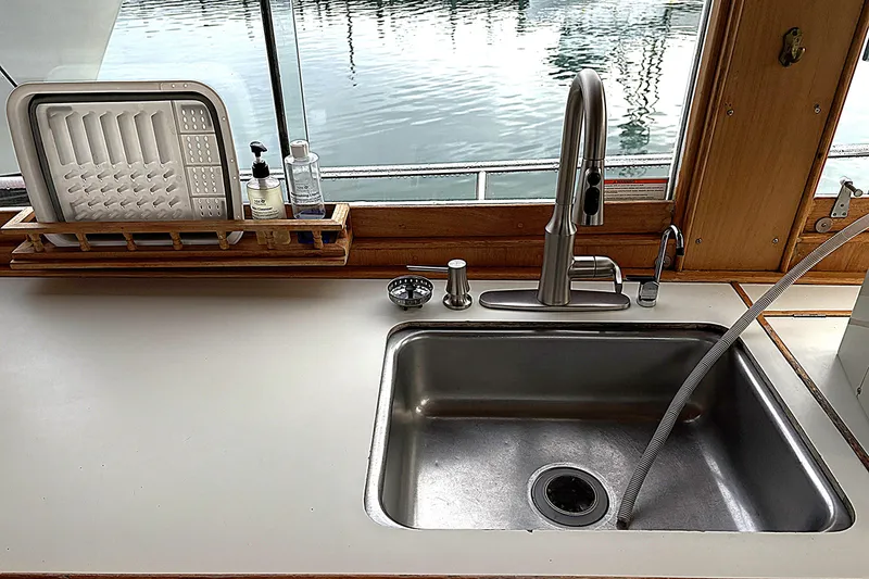 Slide: The Image of 1984 Grand Banks Classic kitchen sink with modern faucet and dish rack by window. - 26